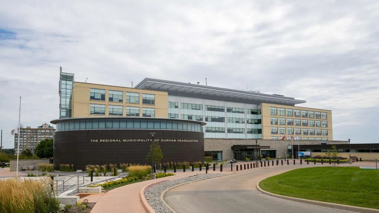 The Regional Municipality of Durham headquarters building in Whitby, Ontario, on a clear day; no people present.