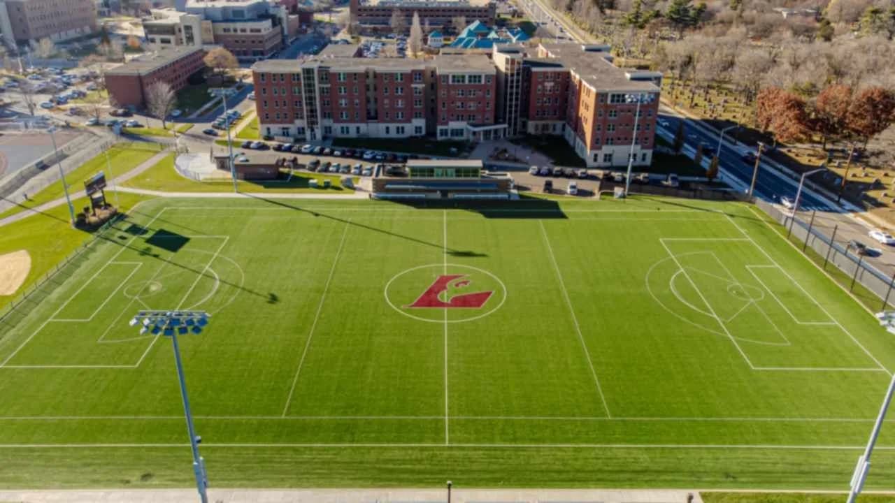 Aerial view of an empty soccer field with spectator stands