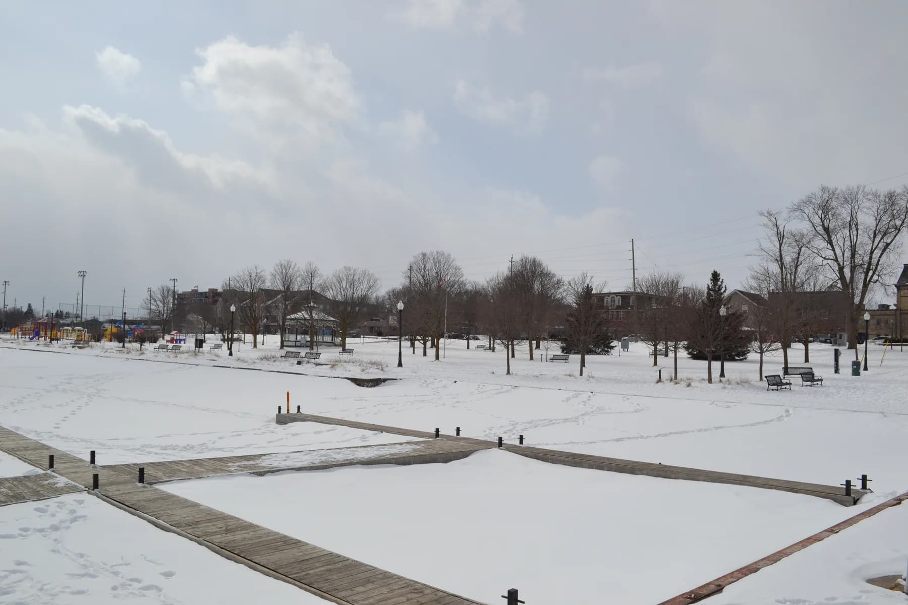 Snow-covered paths, benches and trees at Palmer Park in Port Perry.