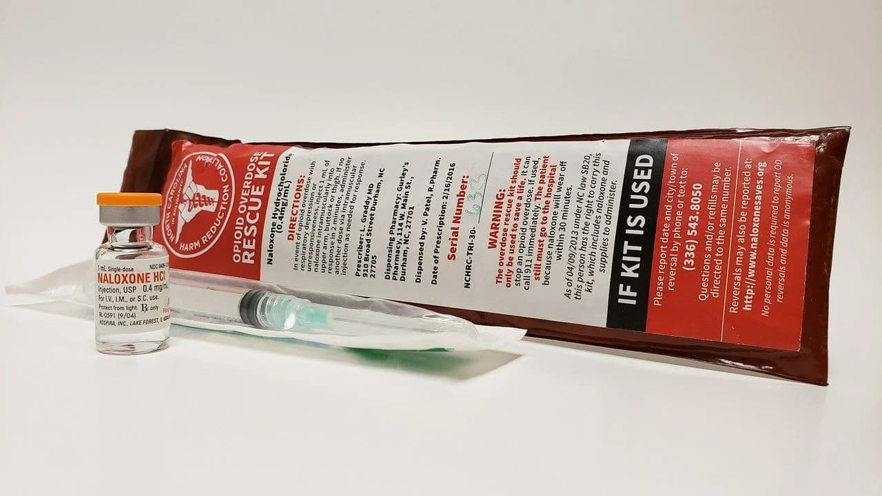 An opioid rescue kit with a naloxone vial and syringe; no people present