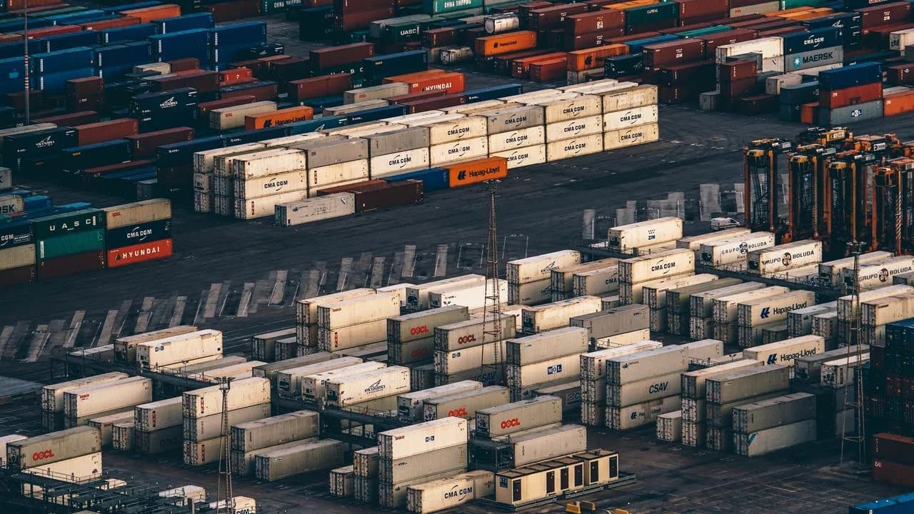 Stacks of shipping containers at a port, seen from above
